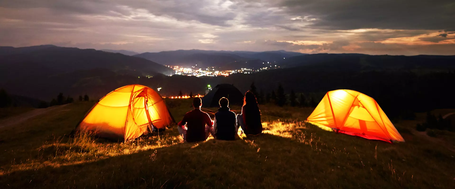 People with tents in the middle of a field