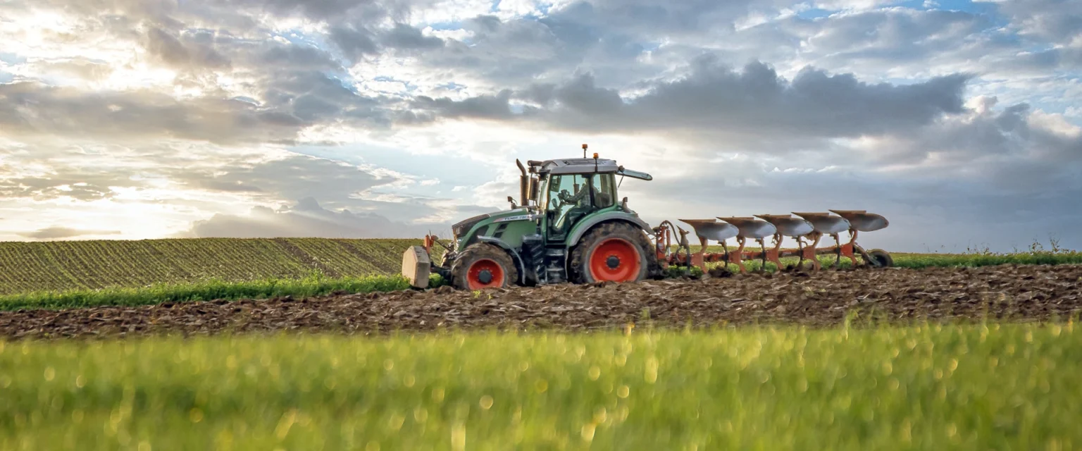 A tractor cultivating a field