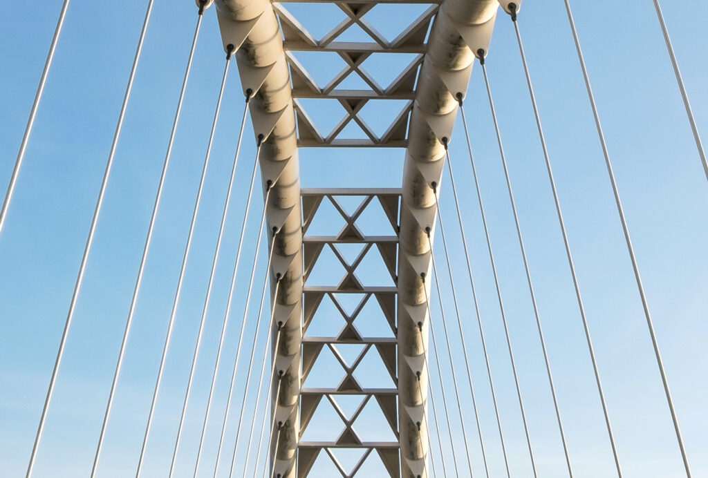 Close-up of a bridge with a blue sky in the background