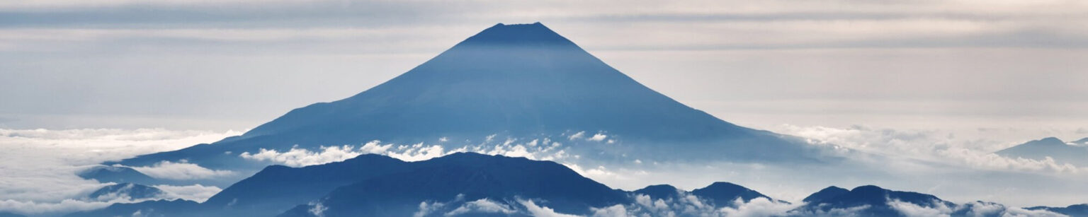 Scenic shot of a mountain top and surrounding clouds